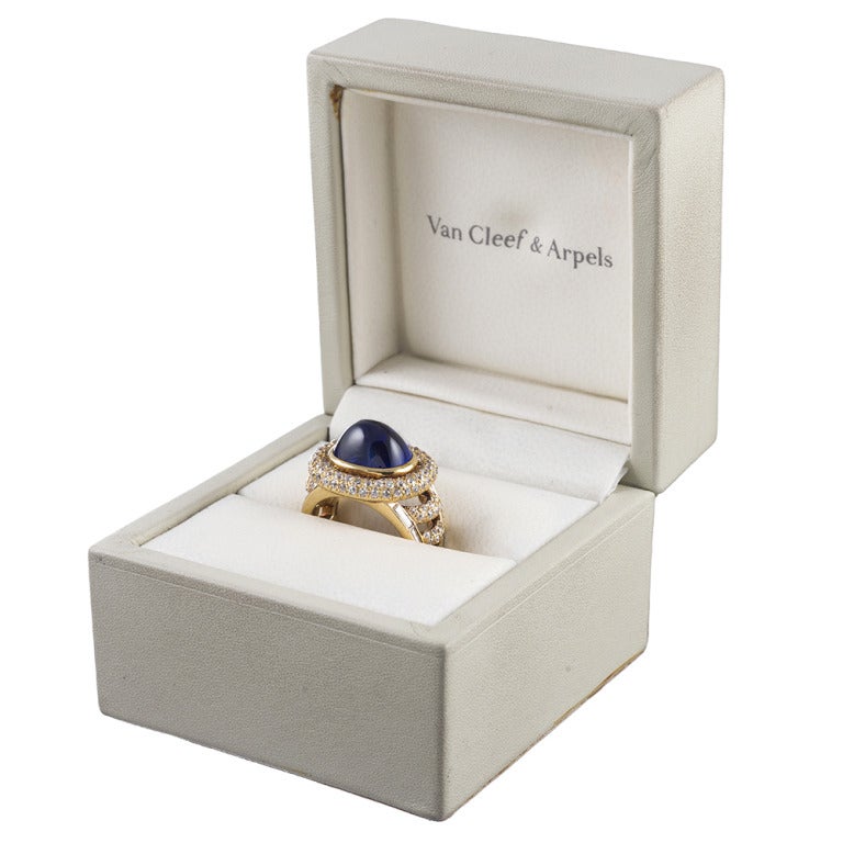 Stunning classic design, with architectural style elements showcasing a striking 11.50 carat cabochon sapphire. The stone is truly magnificent, with super saturated, rich blue color. The mounting is accented with 133 round and 12 baguette diamonds,