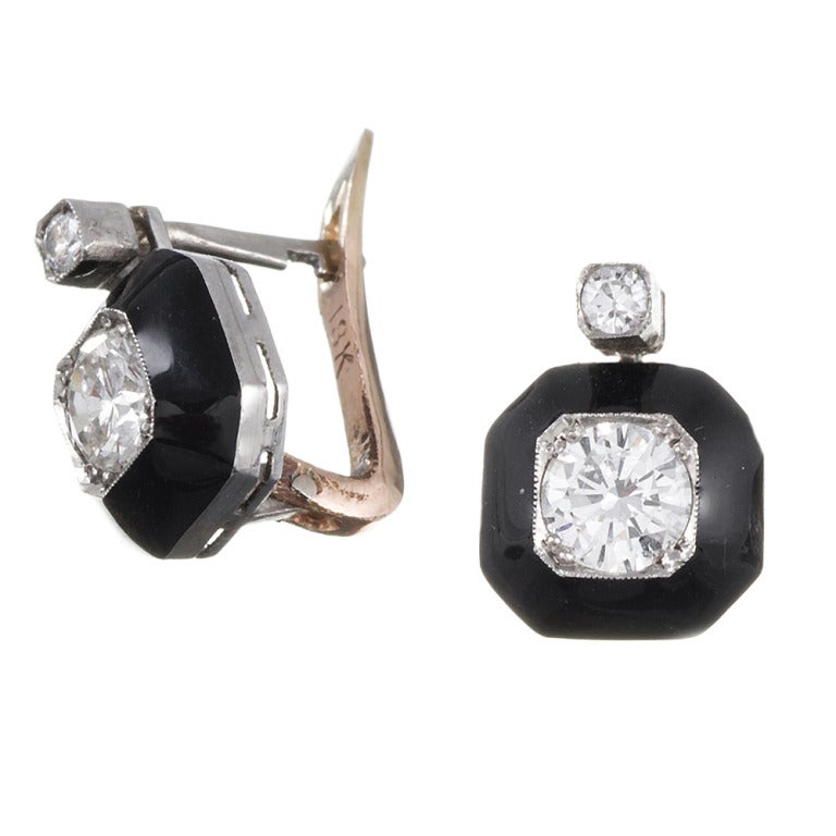 Ideal for every day wear, these understated, yet finely detailed earrings measure just a half inch in overall length, but the striking combination of white diamond and black enamel has quite an impact. The two center diamonds weigh .80 carats in