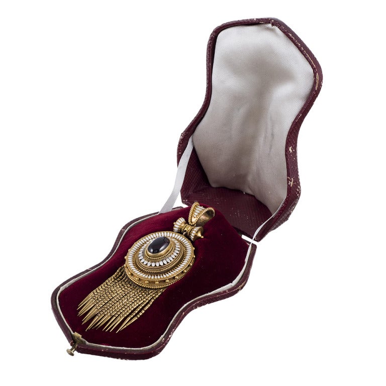 Measuring an extra long 3.75 inches and 1.25 inches wide, this is an exceptionally large pice of fine Victorian heirloom jewelry. Extraordinary detail, with golden granulation, numerous decorations, white enamel trim and a large cabochon garnet in