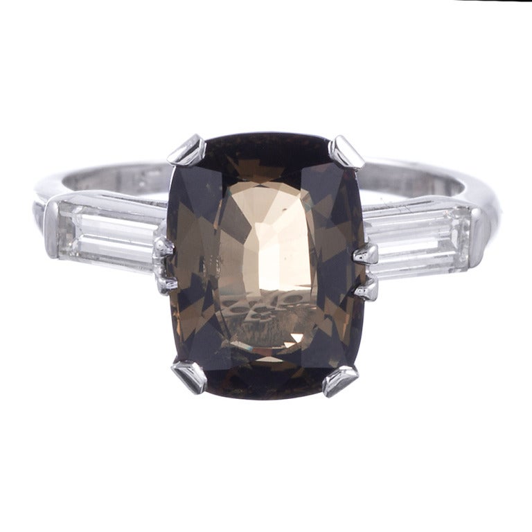 Classic and simple platinum mounting, set with a 4.04 carat alexandrite and flanked with baguette diamonds. The alexandrite is accompanied by a GIA certificate. 
Each diamonds weighs .25 carats.