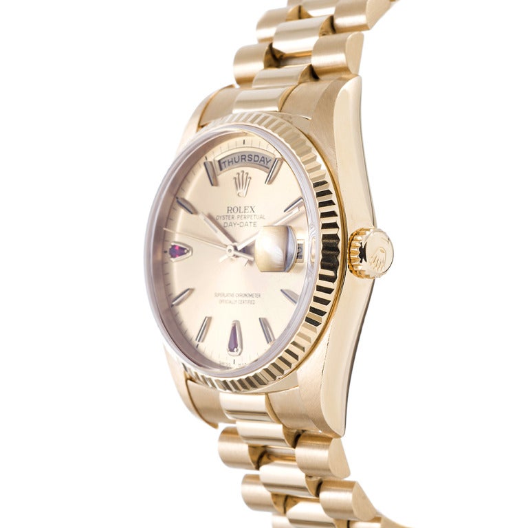 Rolex 18k yellow gold Day-Date wristwatch, Ref. 18238, with a clean monochromatic look, accented with a very rare dial featuring pear-shaped ruby markers at the 6- and 9 o'clock positions. We have never seen its equal. This is a fantastic watch for