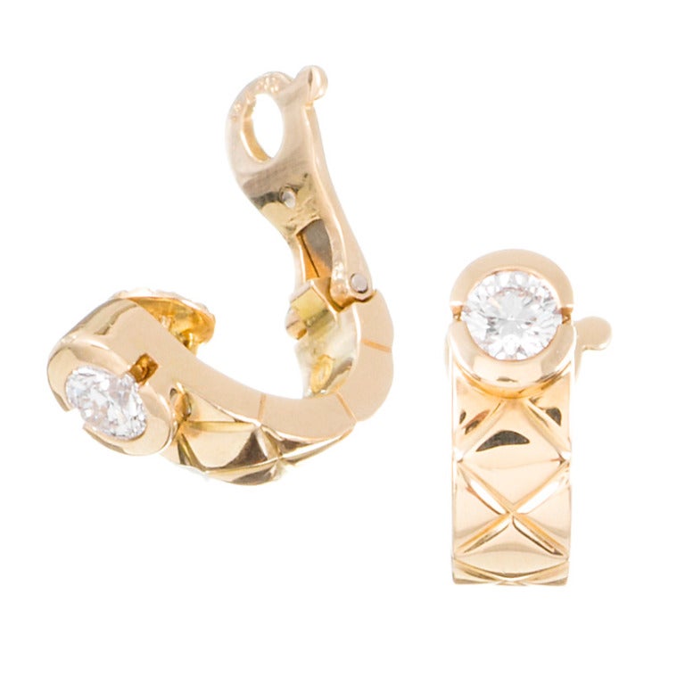 Sophisticated perfection: 18k yellow gold earrings, classic Chanel quilted design, finished at the bottom with a half bezel-set round diamond. Each diamond weighs approximately a half-carat and exhibits very fine F color and Vvs clarity. These are