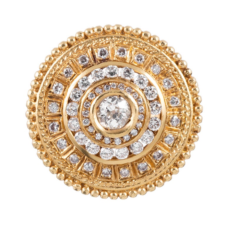 22k yellow gold ring, set with a .40 carat round diamond in the center and further decorated an additional .94 carats of diamonds. This piece combines the detail of Etruscan revival with the substantial look of Byzantine style. It has a surprisingly
