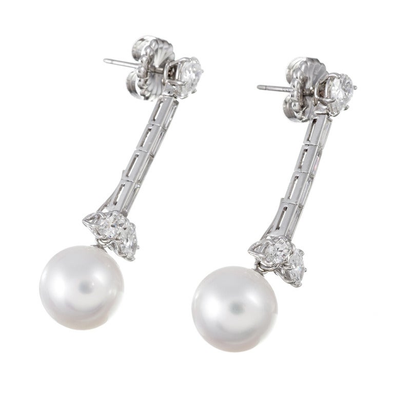 Substantial and classic earrings, ideal for a bride or lover of feminine finery, offering 3 carats of white mixed cut diamonds and punctuated with a 12mm pearl enhancer- the pearl slips on and off of a concealed hook at the bottom of the earring.