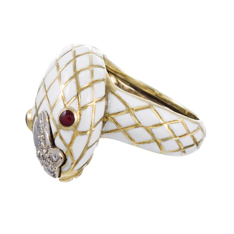 A modernized take on an age old design, American artist David Webb put his touch on the centuries old design of the entwining serpent ring. The snake is larger than classic designs. Bright white enamel in addition to it's unusual size greatly