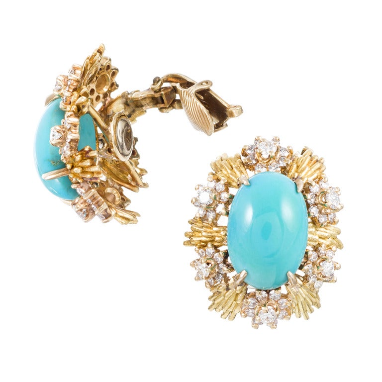 18k yellow gold earrings, cluster design with fine cabochon turquoise centerpieces and frames of textured golden rays, dotted with diamonds. Signed 