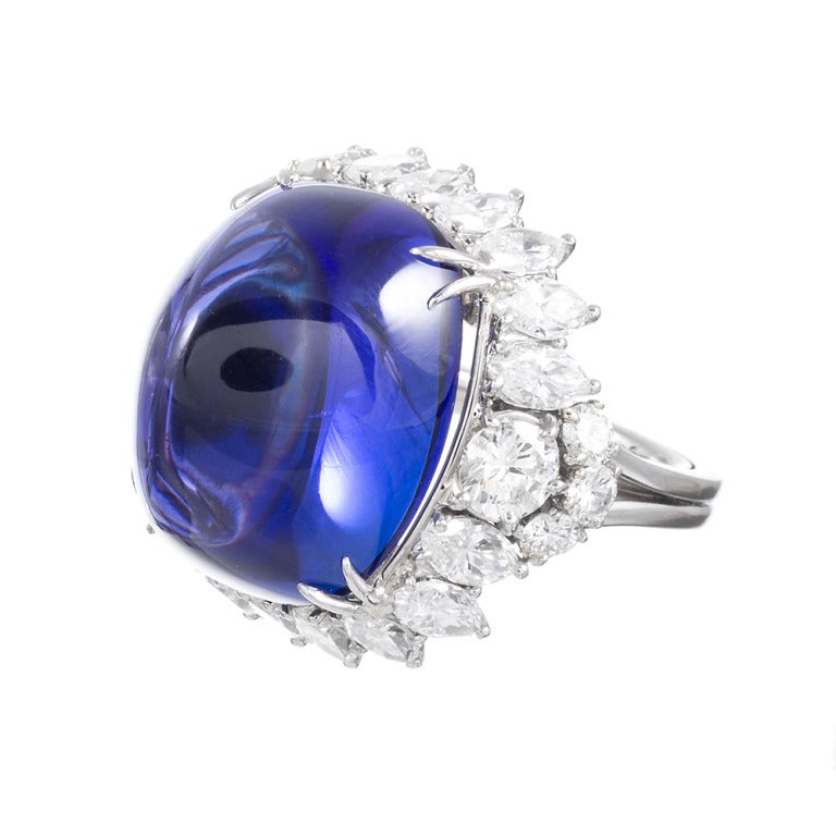 Exceptional in design and execution, this is among the finest tanzanite that we have seen. Nearly resembling a sapphire in certain light, but with dramatic flashes of red in other, the stone captures the attention of all who view it and mesmerizes