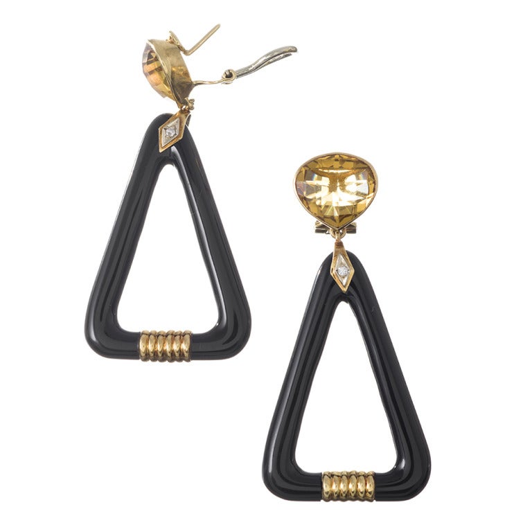 Bold and super chic earrings, just the right length at 2 3/8 inches long, with great movement and a sophisticated vintage style. Carved onyx triangles make up the body, with a golden rondelle at the bottom and a faceted citrine on top. A hint of