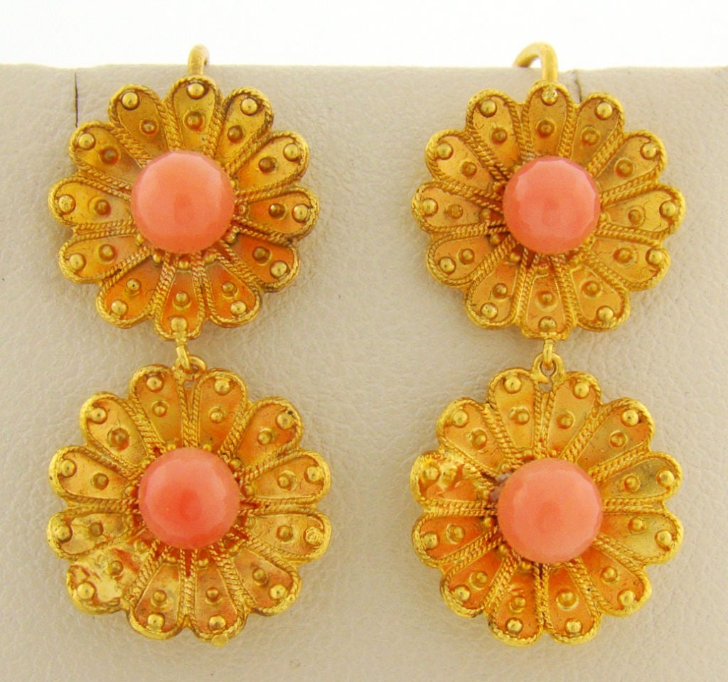 A colorful and fun pair of antique earrings circa 1880. As fashionable today as they were 130 years ago, these earrings are delicate and pretty. The coral beads are bright with pinkish orange color, proving very harmonious with the flower-motif