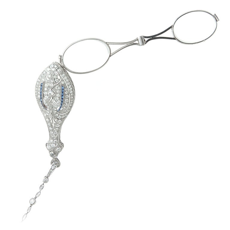 Elegant Lorgnette drop pendant, sparkling flourishes of Diamond and Sapphire accents. Chain interspersed with twenty-nine (29) Diamonds set in Platinum. The perfect gift for a lover of History and Romance!