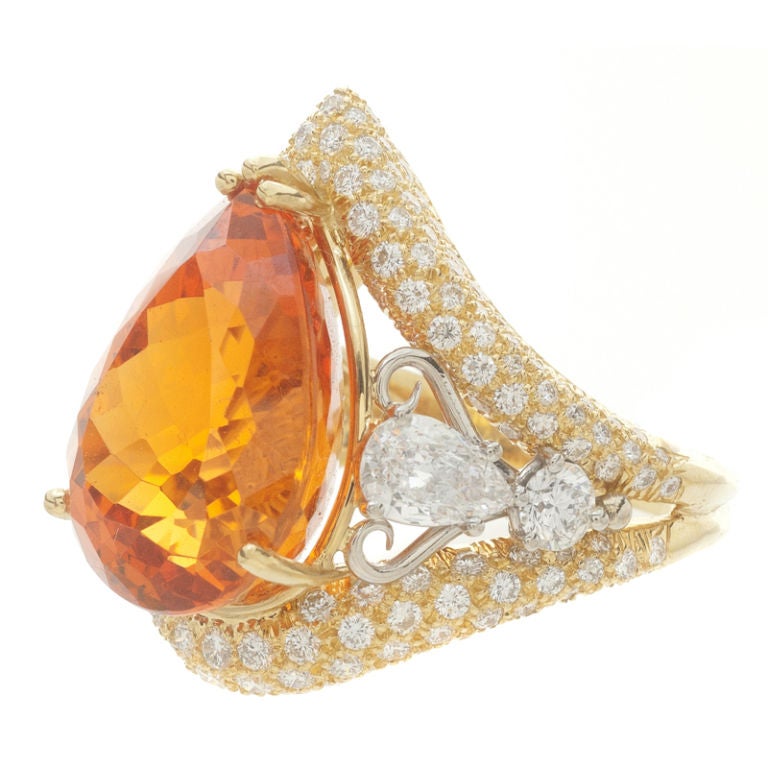 Truly a masterful piece, combining spectacular gemstones with impressive design and craftsmanship. The main attraction is the absolutely beautiful 28.41 carat Spessartite Garnet! Complimenting this amazing gemstone is 4.07 carats fine Diamonds.