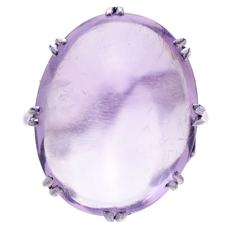 Impressive 22 carat cabochon amethyst period ring mounted in platinum.  Graceful in its simplicity and a lovely shade of amethyst.  Eight double prongs secure this beautiful stone.