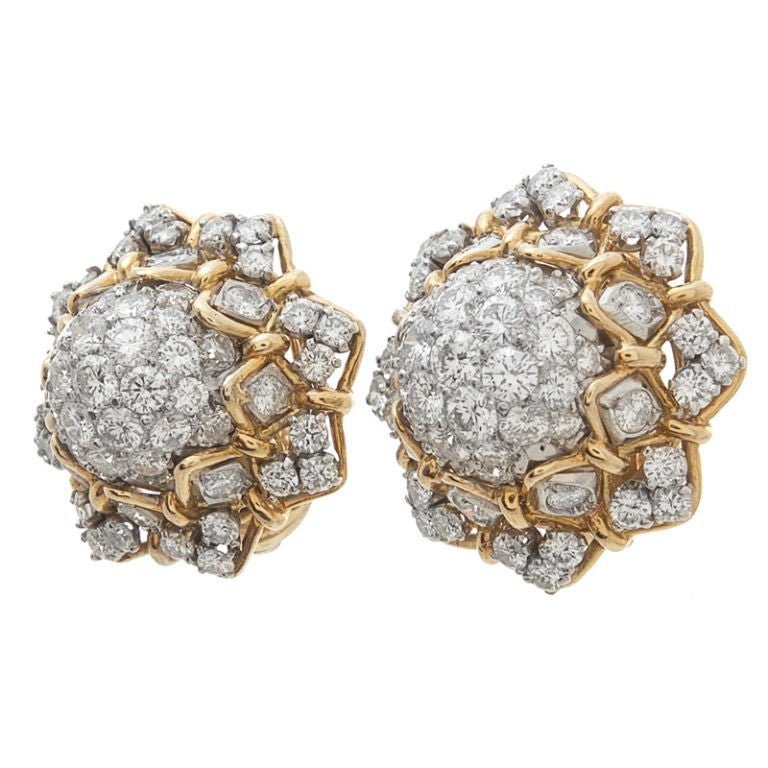 David Webb designed classic diamond cluster earrings.  Platinum and 18 karat yellow gold compliment a total of 100 diamonds weighing 4.5 carats with a superb color grading of F/G and clarity of VVs.  The yellow gold design detailing exemplifies the