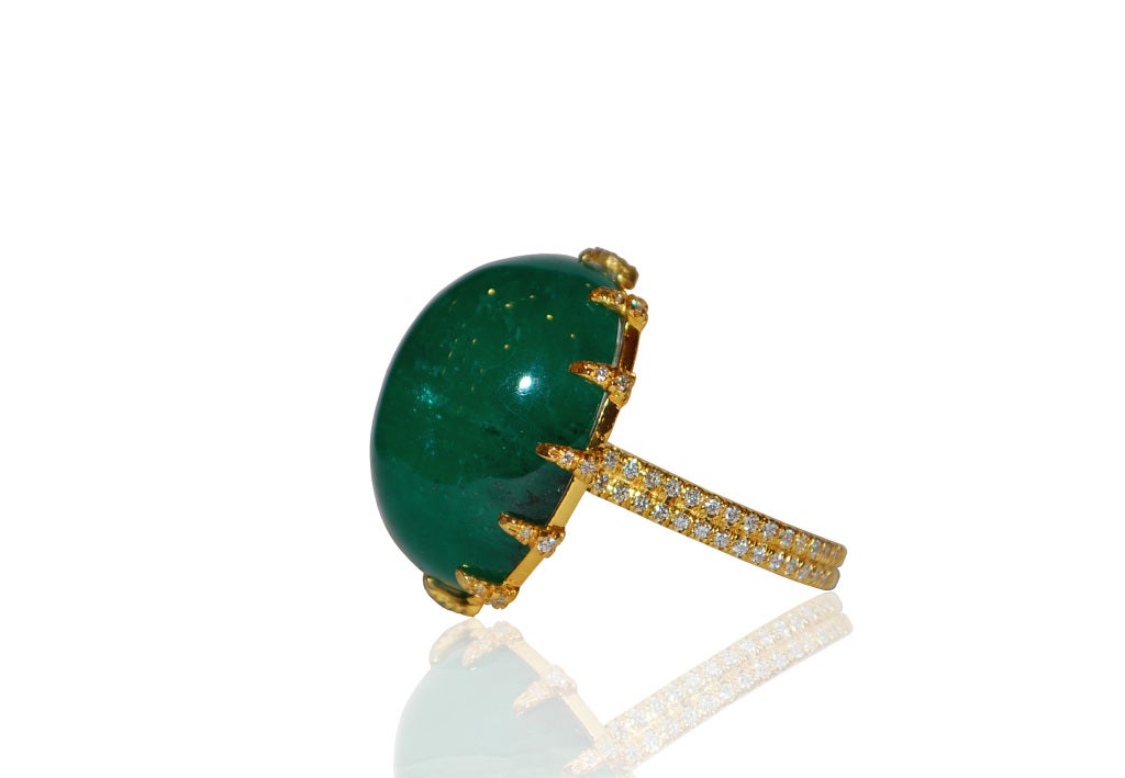 This impressive Emerald cabochon and Diamond Ring has a stunning approx. 25.00 cts center and approx. 3/4 cts of Diamonds with two rows of diamonds set in ring shank and stones in prongs. Size 6.