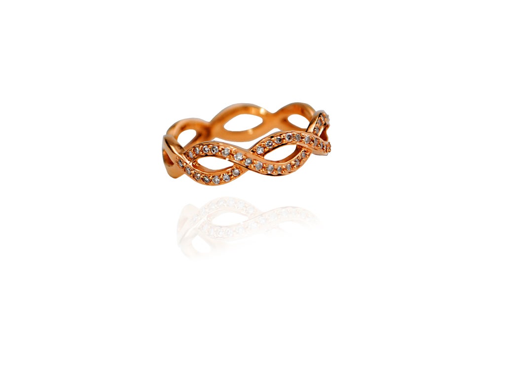 This handmade ring is done in rose gold with a half band of micro pave diamonds. This rose coloration bridges on an almost orange tint, bringing out the brightness of the diamonds. Size 6.5.