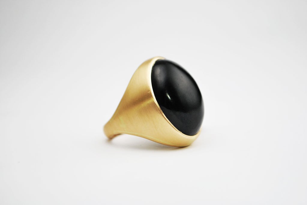 An amazingly smooth black jade stone set into a gold ring done with a satin finish. A heavy but exemplary estate piece for anyone aiming to bring a chic or retro look into their lives. Size 9.5