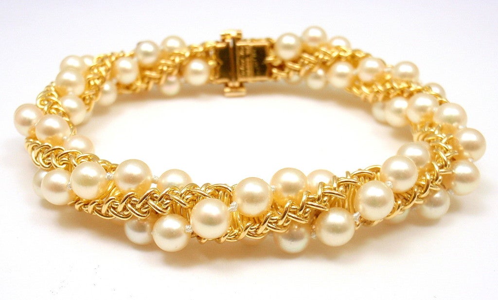 18k Yellow Gold Pearl Wrapped Bracelet by Cartier France. A beautiful vintage Cartier piece made in France. There is nothing similar to this piece available online, making it one-of-a-kind. A truly wonderful piece for the avid Cartier collector.