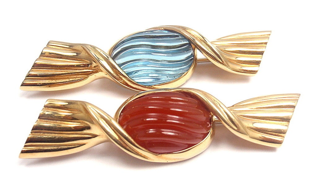 TWO FOR THE PRICE OF ONE! These 18k Yellow Gold BVLGARI Candy Designed Brooches are both rare & fabulous. 

Individual Brooch Stones: 
1. Oval Shape Blue Topaz
2. Oval Shape Carnelian

Weight of each piece: 10.7 grams
Length: 1 3/4