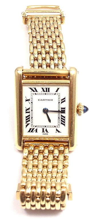 This gorgeous 1970s Cartier Tank watch is made of 18k yellow gold and is in mint condition with a mechanical movement. This rectangular watch is part of Cartier's Tank collection. This watch also comes with an 18k yellow gold Cartier bracelet and