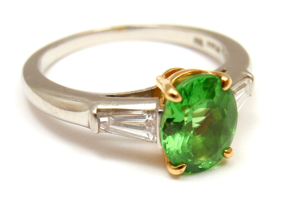 Platinum & 18k Yellow Gold Tsavorite & Diamond Ring by Tiffany & Co. This fabulous ring comes with an original Tiffany & Co. box and a T&CO Retail Replacement Valuation from 09/19/2004. With One Green Tsavorite. Total Tsavorite Weight: 1.72ct. Two