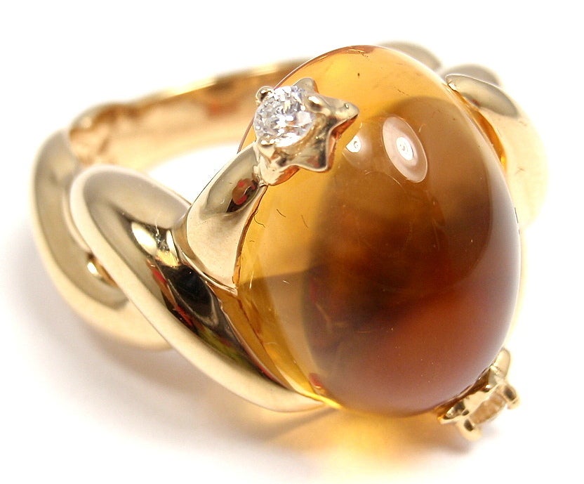 18k Yellow Gold Large Citrine & Diamond RIng by Chanel. With one oval citrine: 16mm x 12mm. And 2 Round Brilliant Cut Diamonds, G/VS1. Total Diamond Weight: 0.10 ct.

Details: 
Ring Size: 6.5. European: 53 (resize available and free of
