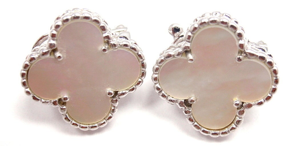 18k White Gold Vintage Alhambra Mother of Pearl Earrings by Van Cleef & Arpels. With 2 Mother of Pearl Motifs. These earrings come with an original VCA box.

Details: 
Weight: 8.3 grams
Width: 15mm 
Stamped Hallmarks: VCA 750 BL 199376
*Free