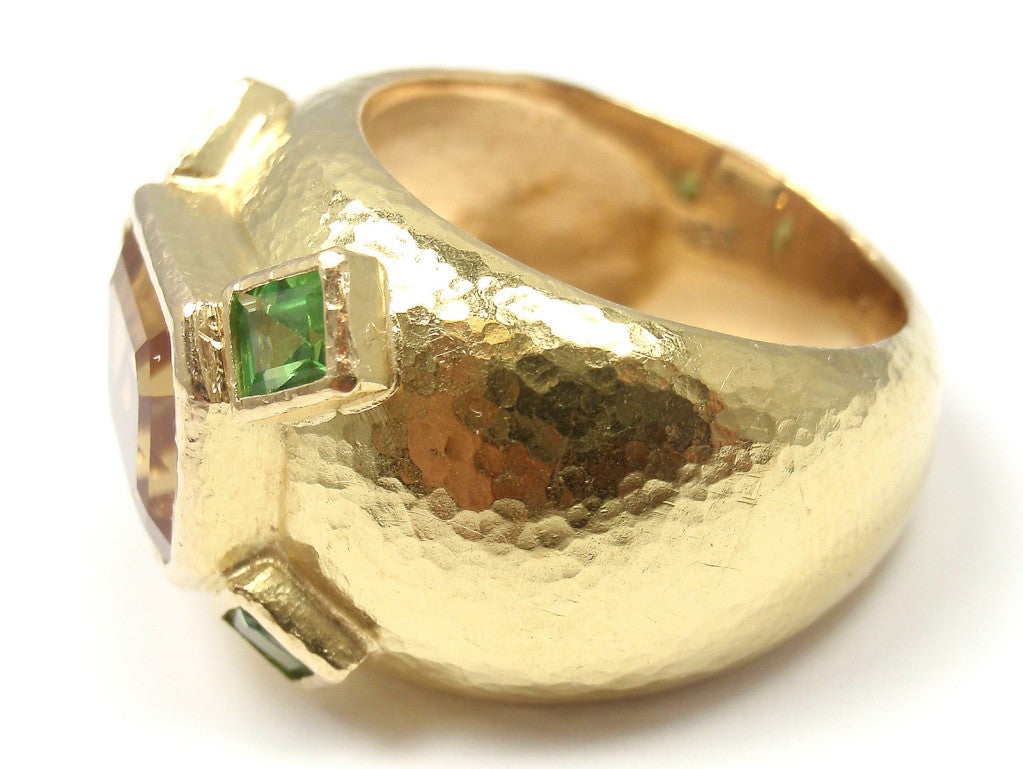 18k Yellow Gold Sapphire & Tsavorite Garnet Ring by Elizabeth Locke. With one large yellow sapphire: 8mm x10mm. And 4 small tsavorites: 4mm x 3mm.

Details:
Weight: 16 grams
Ring Size: 5.5
Width: 15mm front 6mm back
Stamped Hallmarks: