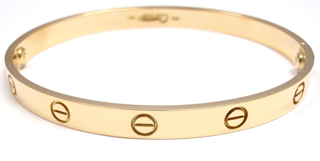 18k Yellow Gold LOVE Bangle Bracelet by Cartier. Size 19. This beautiful Cartier Love Bangle comes with an original Cartier box, Screwdriver and Paper.

Details:
Weight: 31.8 grams 
Width: 6.5mm
Hallmarks: Cartier 750 19 F56912
*Free Shipping