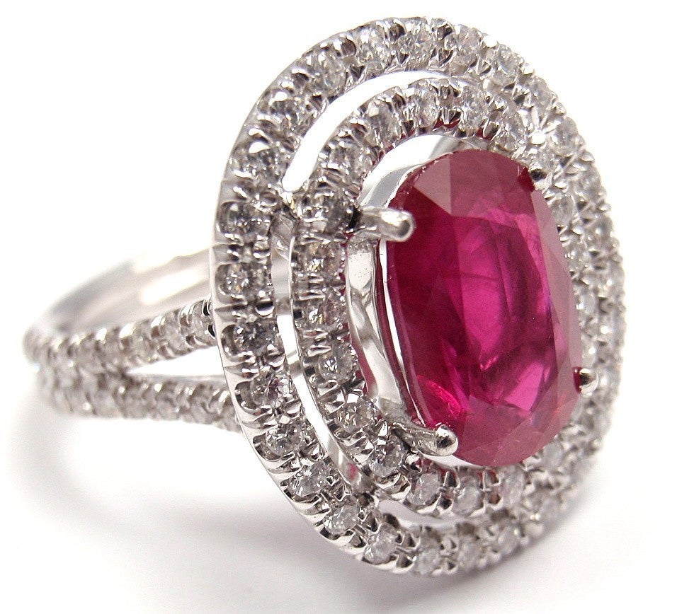 Oval-cut ruby ring, composed of an oval-cut ruby weighing 
3.01 carats (AGL certified: Standard Heat), 
surrounded by .94ct round diamonds VS1 clarity and G color, 
mounted in platinum. 

Details:
Ring Size: 6.5 (re-sizable)
Weight: 10.4