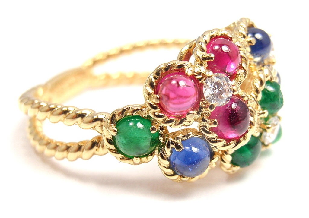 18k Yellow Gold DIamond, Emerald, Ruby, and Sapphire Ring by Christian Dior. With 3 round diamonds, VVS1 clarity, E color. Total diamond weight: .09 ct. Four cabochon emeralds, 3mm each. Four cabochon sapphires, 3mm each. Four cabochon rubies, 3mm