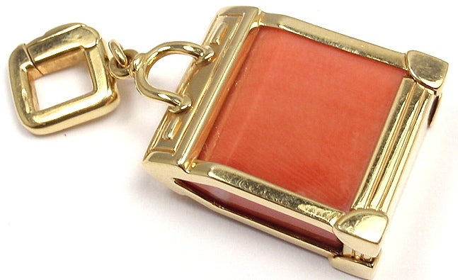 18k Yellow Gold Coral Steamer Bag Charm Pendant by Louis Vuitton. With one coral stone: 20mm x 16mm. 

Details: 
Weight: 13.6 grams
Measurements: 1 1/2