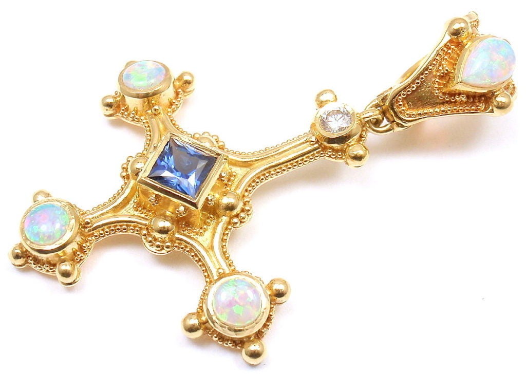 18k Yellow Gold Opal Diamond Sapphire Inverted Cross Pendant by Kent Raible. With 1 round brilliant cut diamond, .20CT. 1 square cut 4mm sapphire stone. And four 7mm opal stones. 

Details: 
Measurements: 1