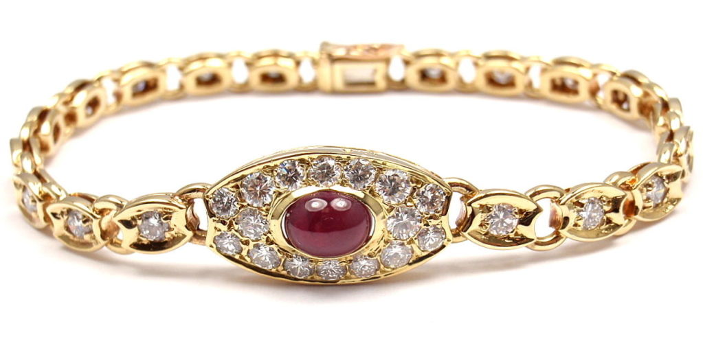 18k Yellow Gold Diamond & Ruby Bracelet by Van Cleef & Arpels. With 34 round brilliant cut diamonds, VVS clarity, E color. Total Diamond Weight: 2CT. And 1 oval-shaped cabochon ruby. Total Ruby Weight: 1CT.

Details: 
Length: 6.5