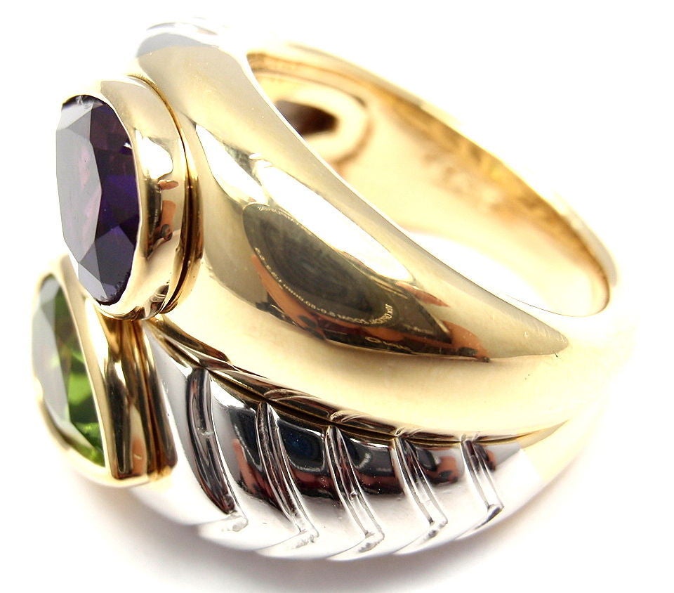 18k Yellow Gold & White Gold Amethyst & Peridot Ring by Bulgari. With 1 Pear-Shaped Amethyst Stone: 11mm x 7mm. And 1 Pear-Shaped Peridot Stone: 11mm x 7mm. 

Details: 
Ring Size: 5 (resize available) 
Width: 17mm
Weight: 18.5 grams
Stamped