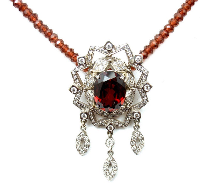 18k White Gold Diamond & Large Garnet Necklace by Doris Panos. With VS1 clarity, G color Diamonds. Total Diamond Weight: 1CT. And one Large Oval Garnet: 15mm x 12mm. Total Garnet Weight: 7CT. 

Details: 
Pendant 2