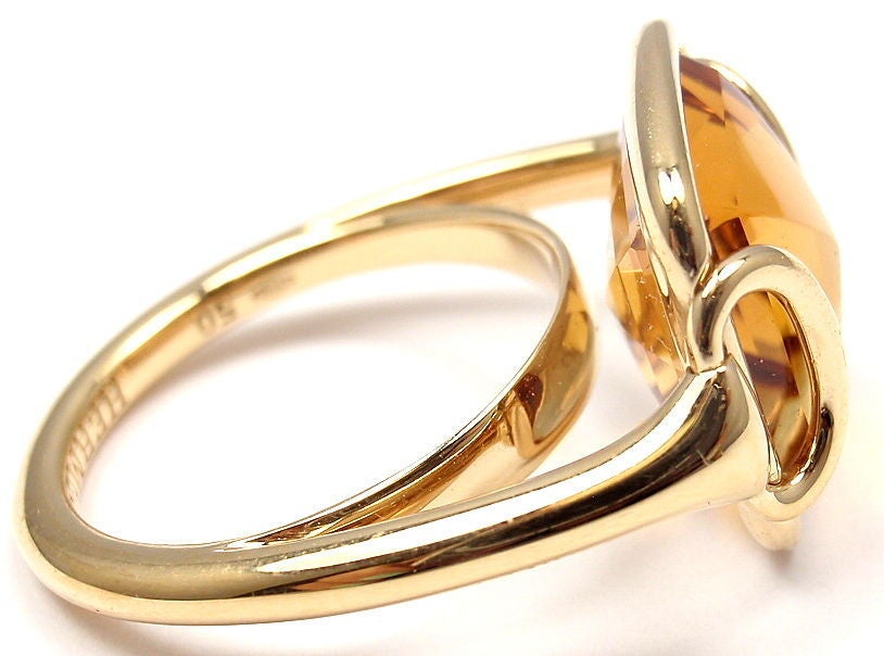 18k Yellow Gold Citrine Horse Bit Yellow Gold Ring. With one beautiful Citrine: 14mm x 12mm.

Details: 
Ring Size: 5 1/4
Weight: 6.5 grams
Width: 14mm
Stamped Hallmarks: Hermes 50 750 07-7052
*Free Shipping within the United States*

YOUR