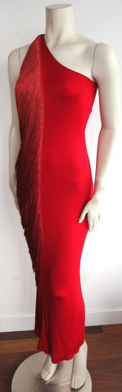 Vintage BILL BLASS early 1970's era scarlet red draped fringe dress.  The draped fringe has a braided attachment to the center front and cascades to the center back.  Concealed zipper entry at the wearer's side seam.  Stretch, slinky matte jersey