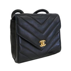 CHANEL PARIS Black leather chevron topstitched small purse bag