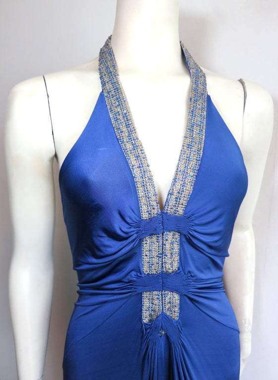 ROBERTO CAVALLI Sapphire blue crystal halter neck evening dress.  Draped, silky viscose fabrication with blue Swarovski crystals and clear hand beading at front and halter neck band.  Silver Lurex front embroidery detailing with ruche detail,