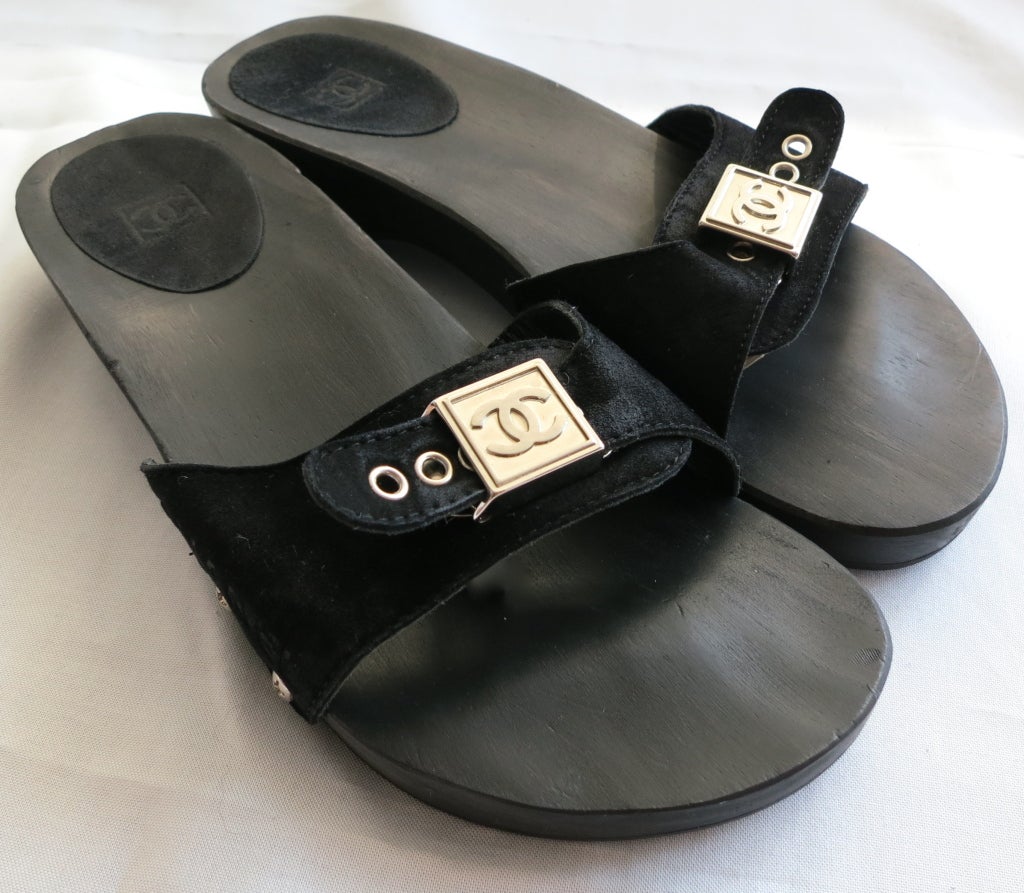 Worn only a few times, Chanel suede front wooden heel clog sandals with adjustable hardware front.  Embossed suede rear heel insoles.