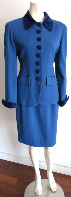Vintage, 1980's era Christian Dior royal blue wool crepe and velvet trim suit.  Velvet collar, covered buttons, and wing tip style french cuffs.  Dual waist level flap detail, patch pockets. Fully lined