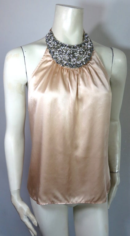 MOSCHINO Silk charmeuse hand beaded crescent halter top with clear & lavender tone cubic zirconia stone embellishments.  Gathered detail construction at the neck, with self fabric sash tie at rear neck.  Frosted peach color silk body