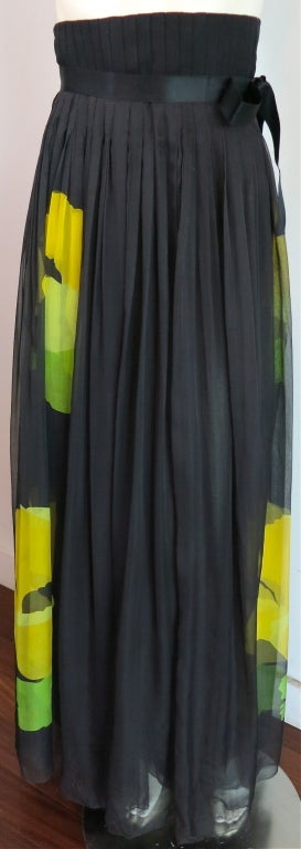 CAROLINA HERRERA Pure silk floral high waisted skirt.  Pleated waistband with dual hook and eye, as well as zipper closures at wearer's left side seam.  Double layer silk chiffon with oversized citron color, poppy floral motif.  Ribbon tie with bow