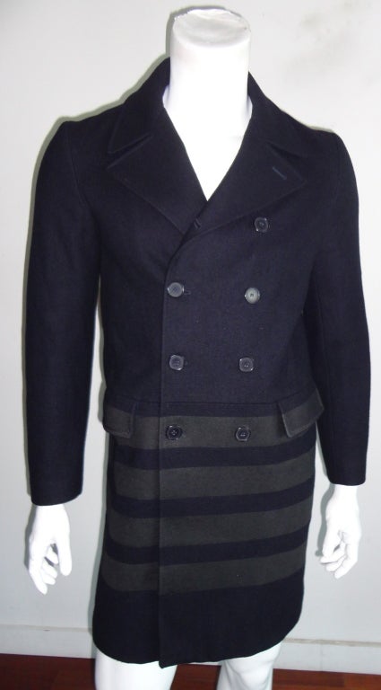 Original HELMUT LANG 1997 navy blue over coat with black coated stripes at bottom.  Double breasted front closure with dual waist level flap pockets.