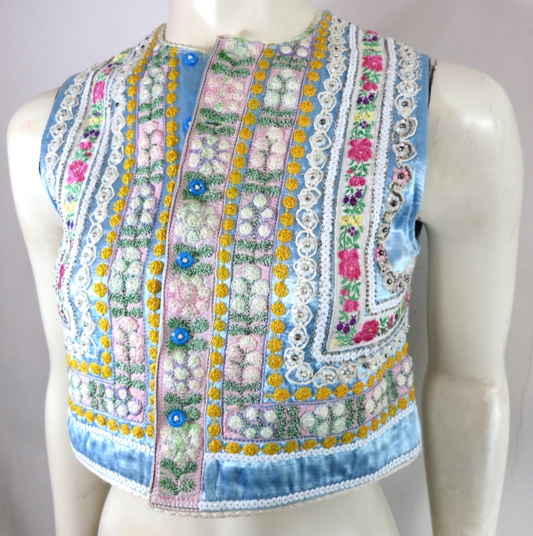 Vintage 1970's era floral hand knotted embroidered satin vest with beaded embellishment detailing.  Button front entry