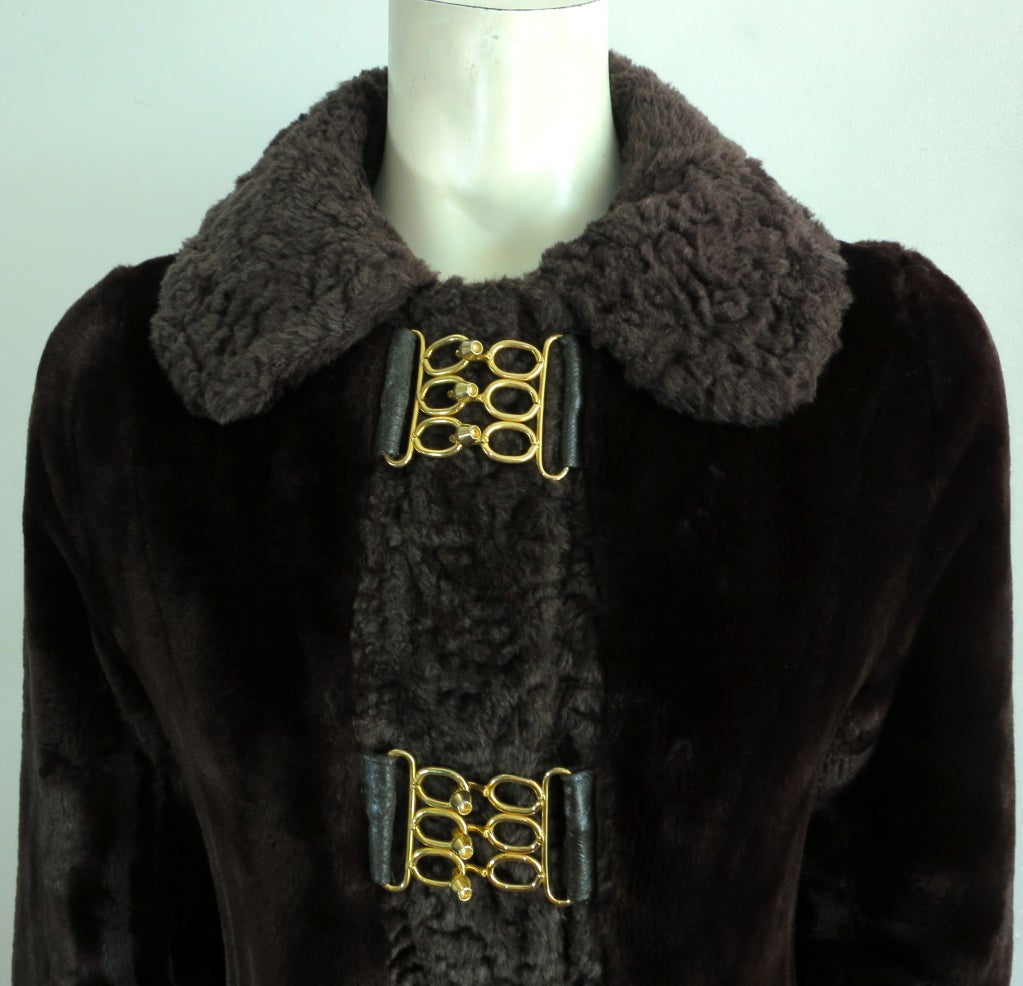 Vintage ED MILLSTEIN 1960's faux fur coat in dark brown with gold finish ring front hardware closures at front.  Fully lined. Underarm to underarm: 16