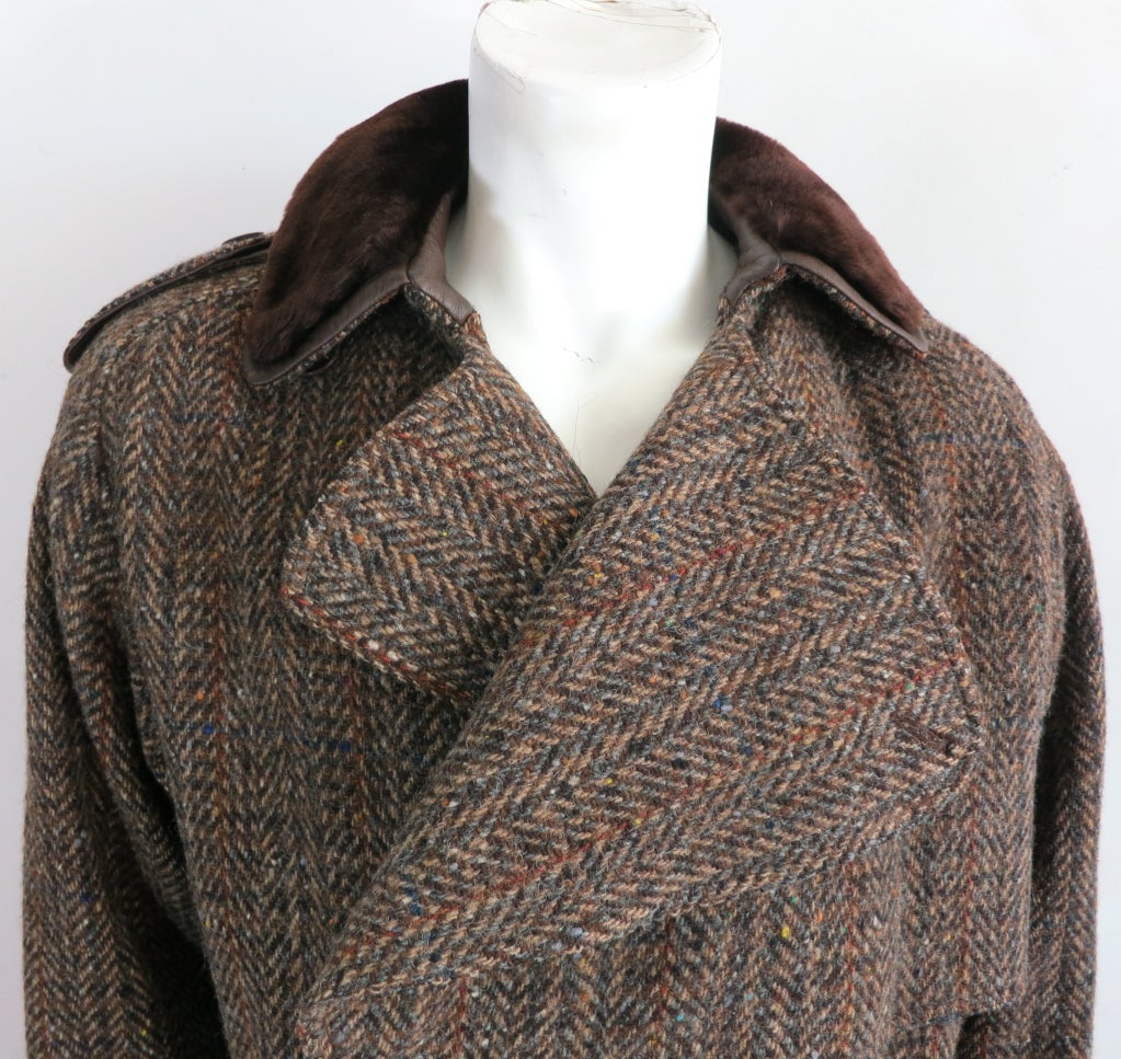 Vintage GUCCI 1970's era herringbone tweed coat with matching belt.  Double breasted front with leather, logo engraved button closures.  Faux fur & leather top collar with leather underside at belt.  Adjustable sleeve belted detailing with button