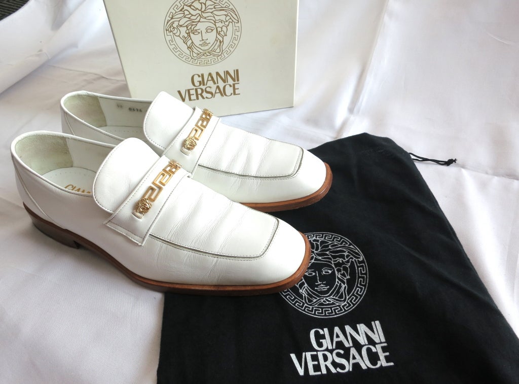 Gianni Versace early 1990's white leather loafers with signature greek key and Medusa head gold front embellishment hardware.  Includes the original box, and dust bag.