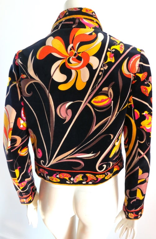 Vintage EMILIO PUCCI 1960's geometric floral velvet jacket in black ground with orange, yellow, .  Engineered border print at collar, front placket, hem, and cuffs.  Open front design.  Fully lined.

Underarm to underarm: 19