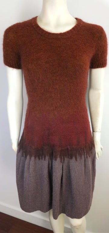 NINA RICCI by Olivier Theyskens needle punch ombré sweater dress.  Orange to red ombre effect top with needle punch bottom gray wool skirt.  The inside features a silk tulle skirt under layer for volume.  Concealed side seam zipper at wearer's